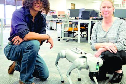 From coding commands to wagging circuits — Zavien Napoleon-Sullivan (L) and IT instructor Tametha McNelley (R) team up with Neo the robotic dog to show that the future of tech is anything but boring at WWTC.