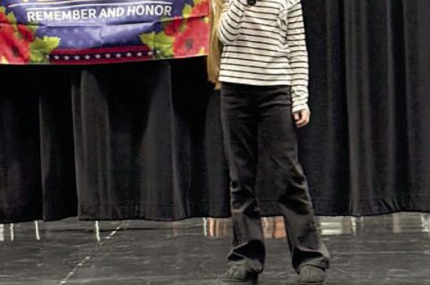 3rd Grade student, Ema Hebert, performing 'God Bless America'