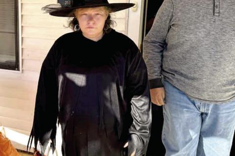 Jennifer riding her broom to get candy!