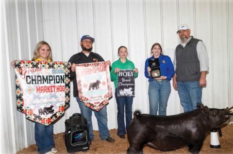 Moss FFA Member Avery Tyler (pictured in blue FFA shirt) earned Grand Champion Market Hog and Champion Senior Swine Showman