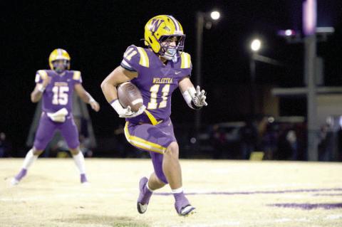 Junior Noah Hare moves the ball upfield for an Outlaw first down.