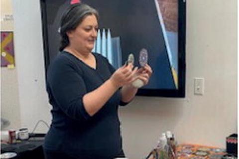 Instructor, Laura Calvery shows the class some of the basic Mandala samples that can be completed with a little practice.