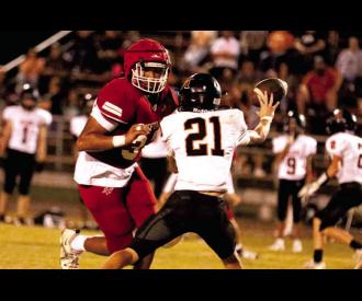 Phillip Ross closes in on the Longhorn quarterback. Photos by Dane Smart, Tribune Sports Reporter